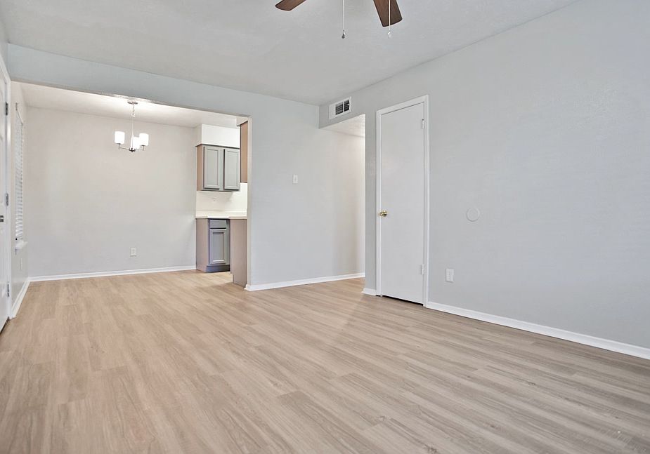 Spacious dining and living area with wood-style flooring