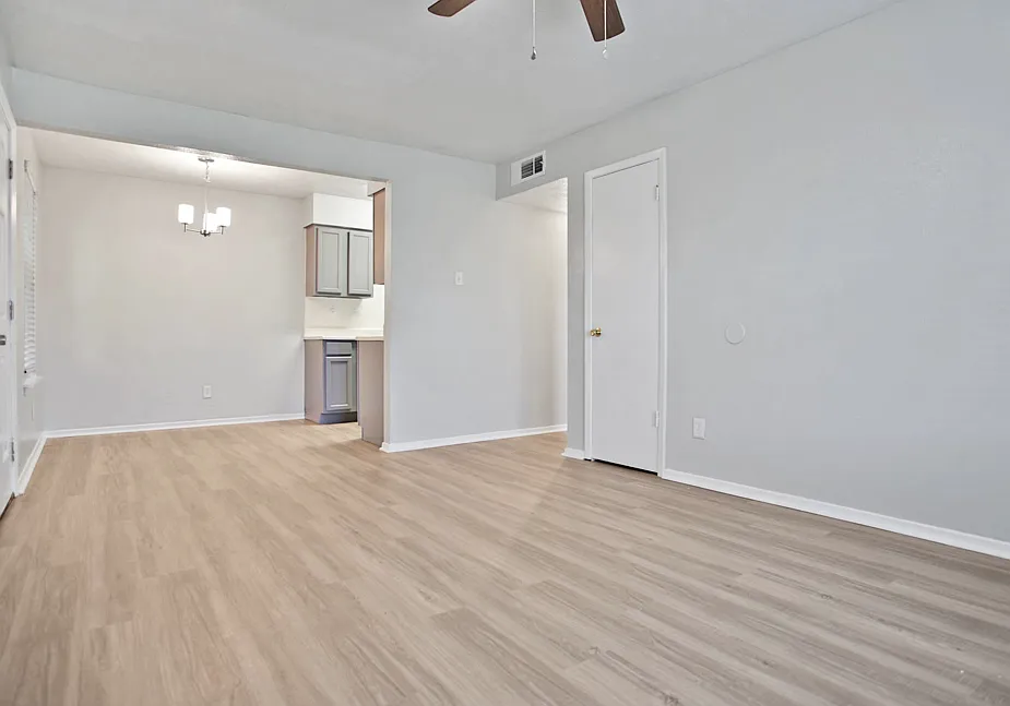Spacious dining and living area with wood-style flooring