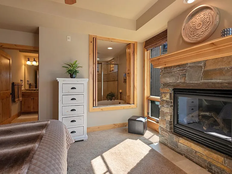 Master bedroom fireplace and bathroom suite in rear, soaking tub