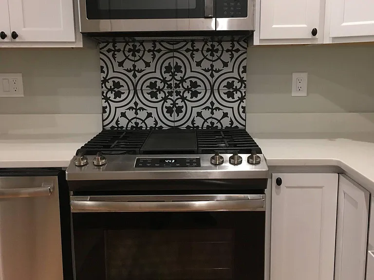 Gas range and microwave with exhaust fan above.