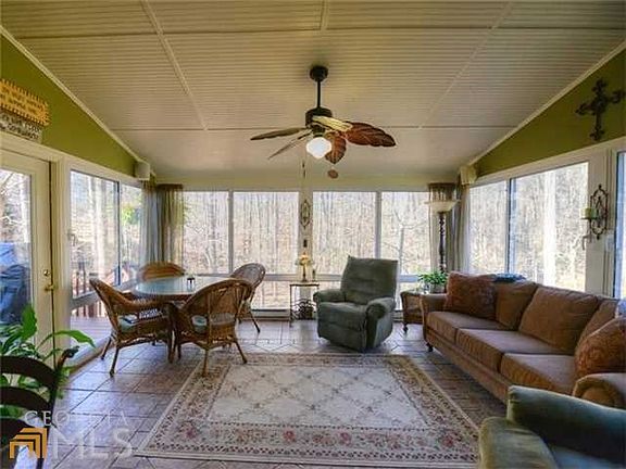 Another view of the beautiful sunroom overlooking the wooded lot!
