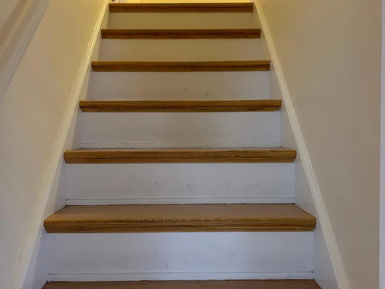 wood stairs lead to 2nd floor