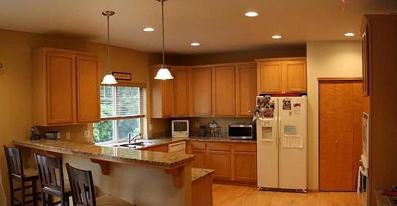 Kitchen offers granite counter tops and room galore