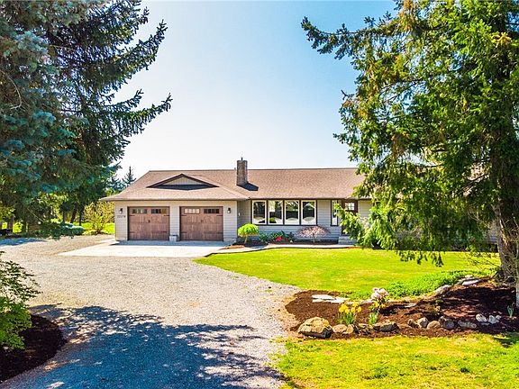 Freshly landscaped yard, with a nice mix of mature landscaping.