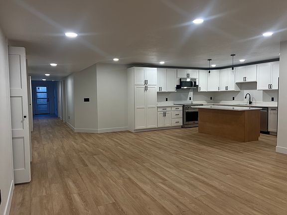 The spacious kitchen comes equipped with brand-new, top-of-the-line appliances, including an LG refrigerator, LG microwave, LG dishwasher, and a 36-inch Cosmo convection oven, ideal for culinary enthusiasts.