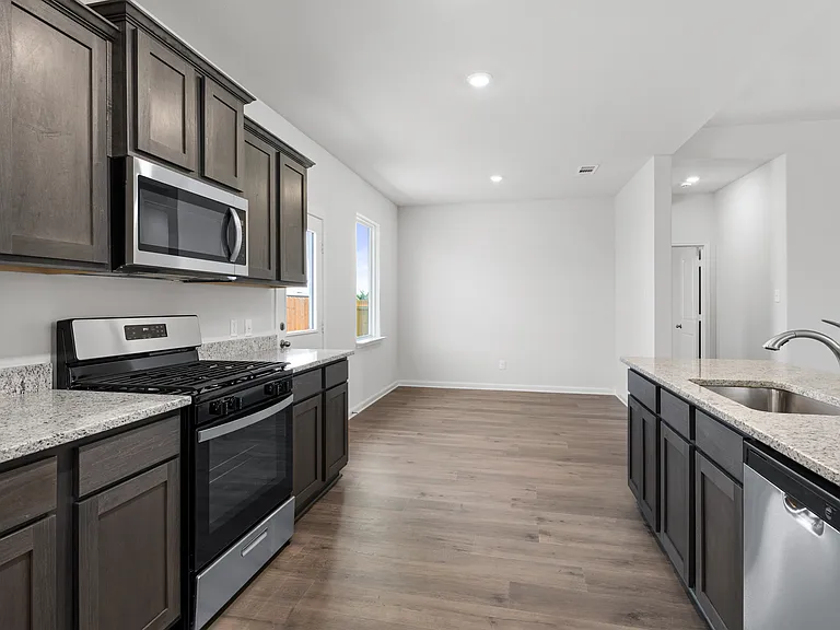 The kitchen has sprawling granite countertops.