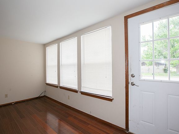 Enclosed front porch adds its charm