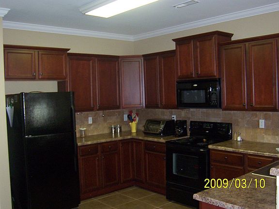 Kitchen with tile flooring/backsplash. Under cabinet lighting. Pantry.