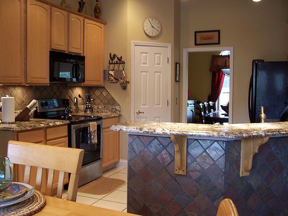 Kitchen with granite,slate and accent lighting