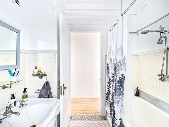 Behind the door is a bathroom closet with many shelves for ample storage!
