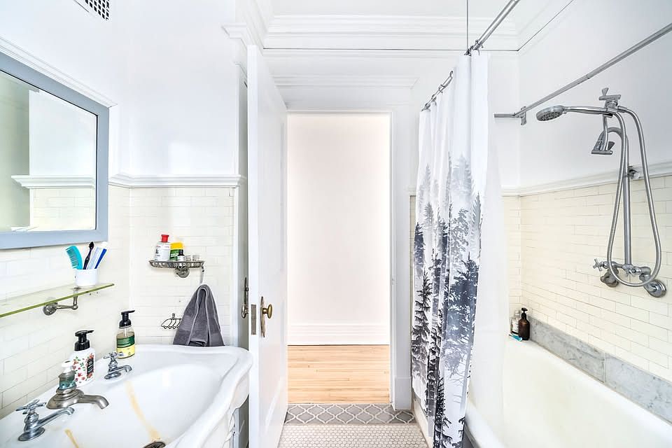 Behind the door is a bathroom closet with many shelves for ample storage!