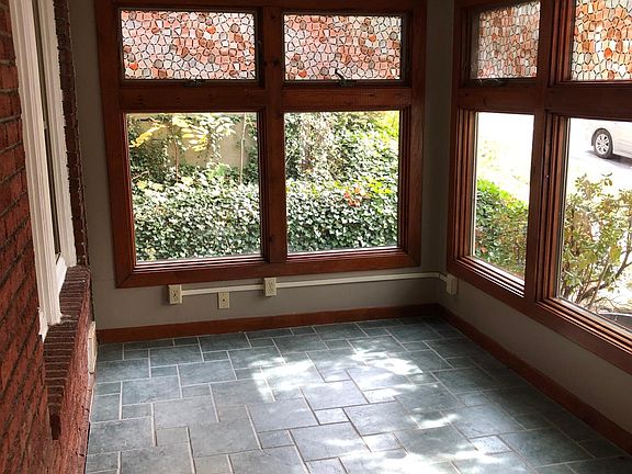 Large windows provide plenty of light, while the plantings give some privacy
