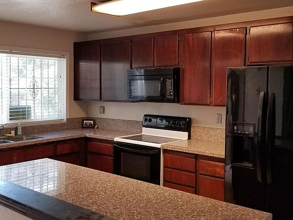 Beautiful kitchen boasts granite counters, lots of cabinets and open to dining room and family room