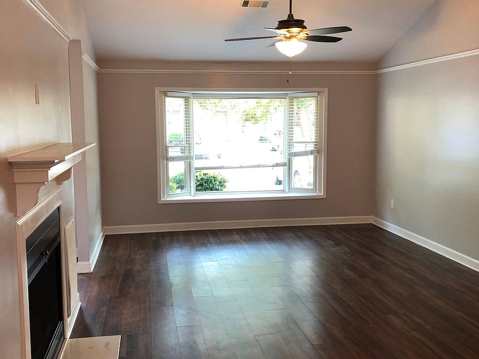 Great room looking from dining area to living area with bay window