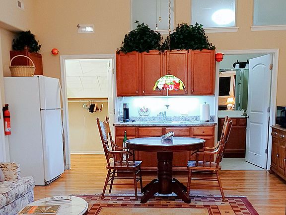 "Wet bar" with casework. Full-size refrigerator on left. To the left of the wet bar is the walk-in-closet. To the right in the bathroom.