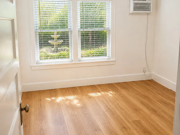 Bedroom 1 of 2 with view of large private yard and large closet