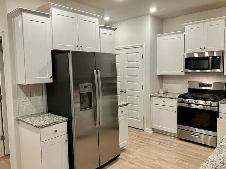 Kitchen with new stainless steel appliances and pantry closet