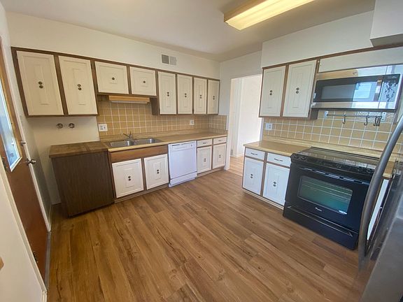 Kitchen with lots of cabinets, refrigerator, range/oven and dishwasher