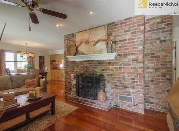 View from entryway of gas fireplace and open concept living/dini