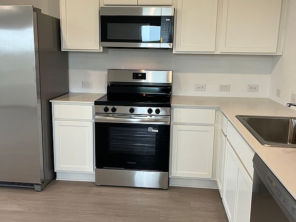 Kitchen with refrigerator, stove, microwave, and dishwasher