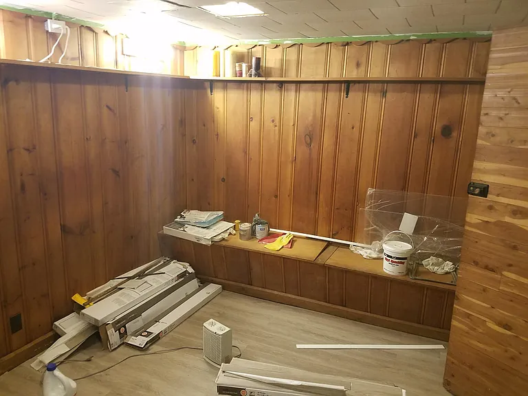 Cedar lined basement room with work equipment that will be removed.