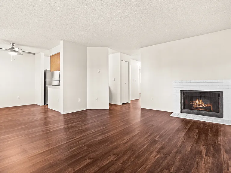 Spacious living area with fireplace and wood-style flooring