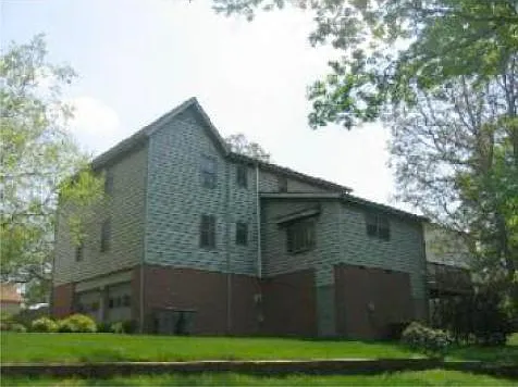 Back view with garage and walk-in basement.