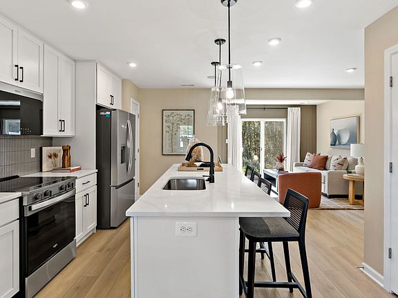Spacious kitchen featuring a large center island and bright furnishings.