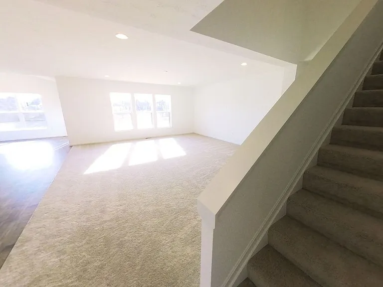 Stairs leading to bonus bedroom upstairs (with full bath!)
