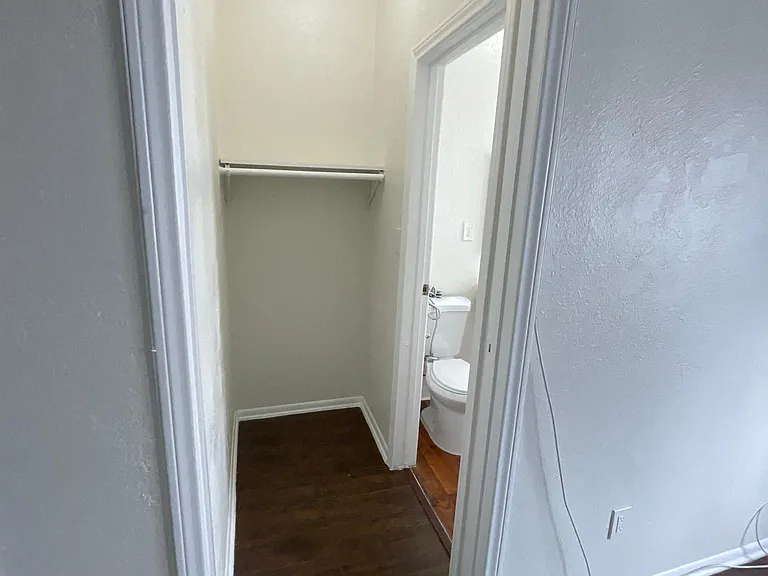 Hallway view of bathroom at Sanborn/Hoover Apartments in Los Angeles, CA.