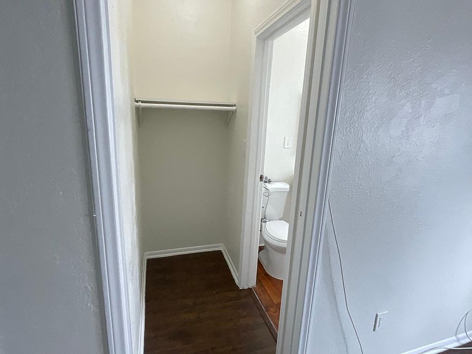 Hallway view of bathroom at Sanborn/Hoover Apartments in Los Angeles, CA.