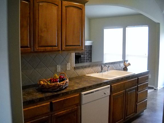 Kitchen overlooks family rm