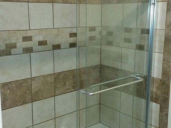 Earth tone tiled bathrooms