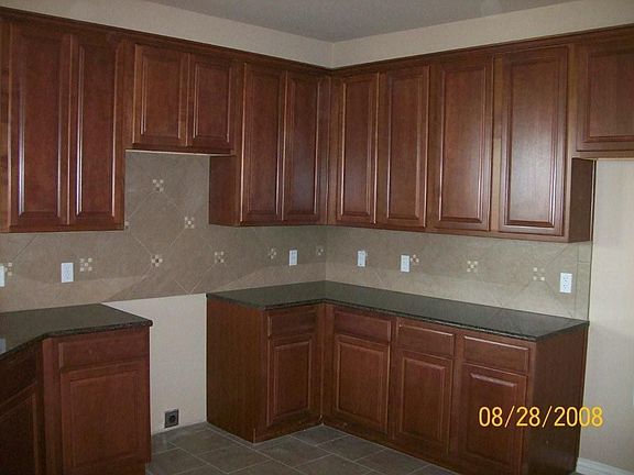 large kitche w/granite counters and ceramic tile backsplash & floors