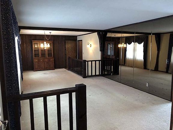 View upon entering the home.  Deceiving in the sense that it is a full mirrored wall.   This is the formal living room with the dining room in the background.