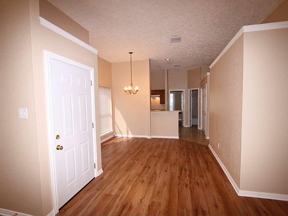 FRONT DOOR INTO LIVING AREA WITH WOOD LAMINATE FLOORS