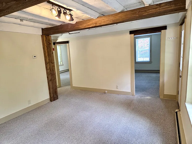 Living room area looking into two back bedrooms