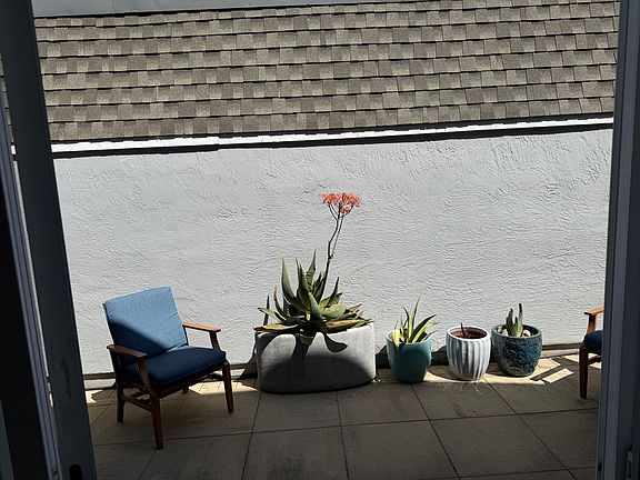 Chair and potted plants are for display purposes only. Only the largest potted plant will remain.