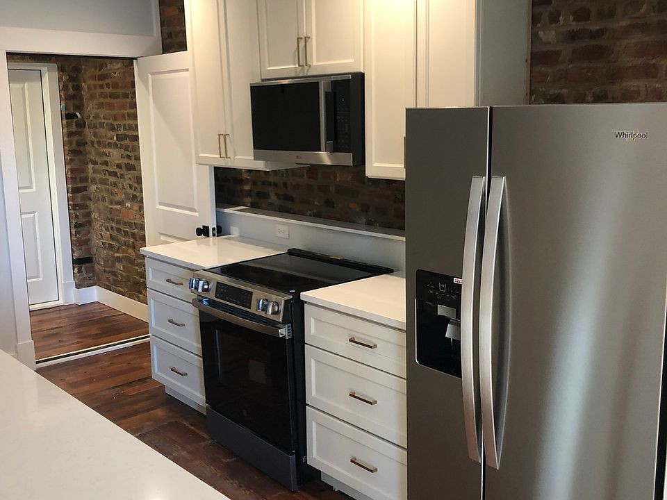 Exposed brick was retained with modern cabinets and upscale appliances.