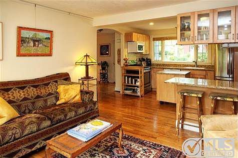 Den and kitchen.  LOVE those hardwood floors!