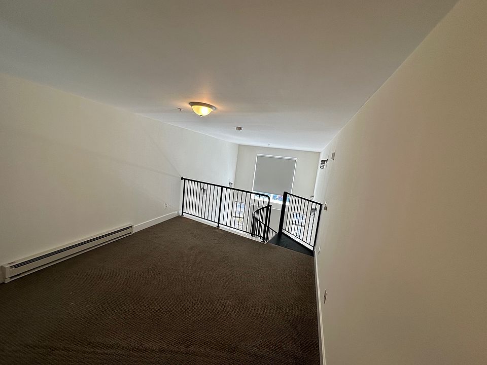 Lofted bedroom area looking toward staircase