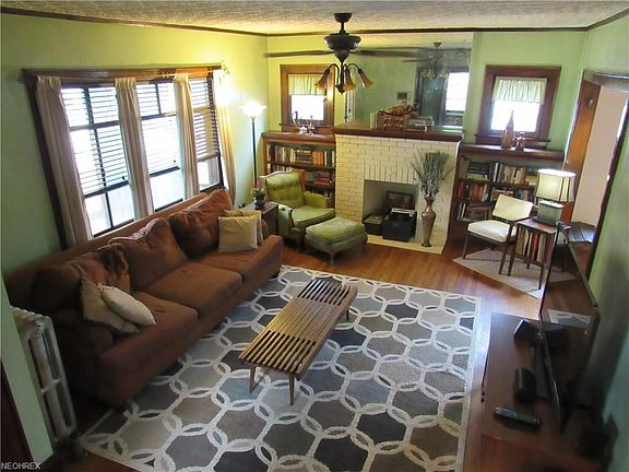 Spacious living room with bay window, beautiful oak wood floors, trim and built in bookshelves.