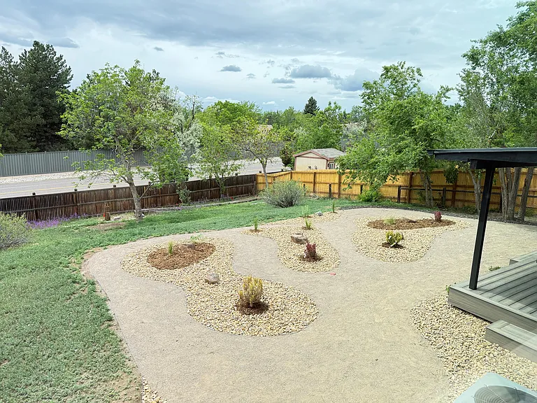 View of backyard from primary bedroom, showing covered deck
