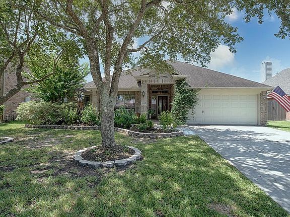 A view of the front of the home with fabulous shade from two gorgeous oak trees. Certain to aid you from the summer heat.