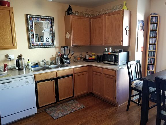 The kitchen has a fridge, electric range and dishwasher. There is space for a small table and chairs.