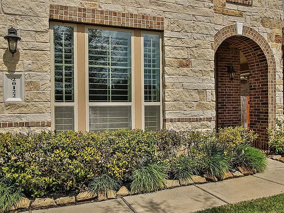 Beautiful landscape accentuates the stone work, a blend that really makes this home look spectacular from the outside!