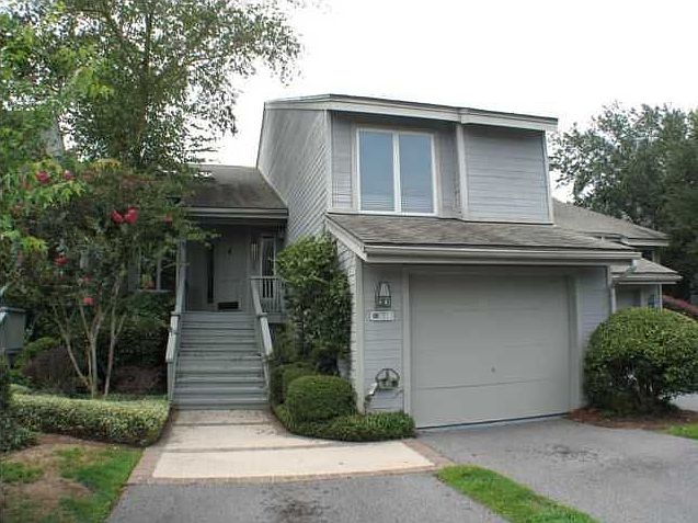 Front of the condominium features a spacious 1 car garage with ample storage