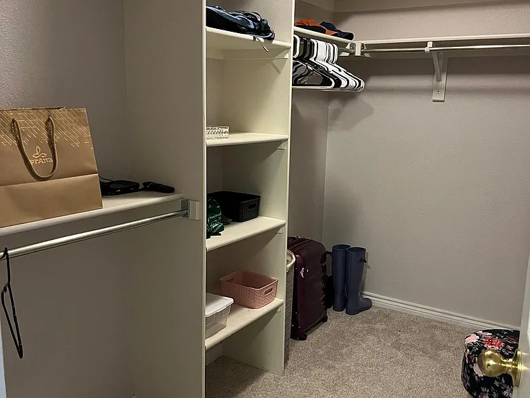 Walk-in closet with large mirror.