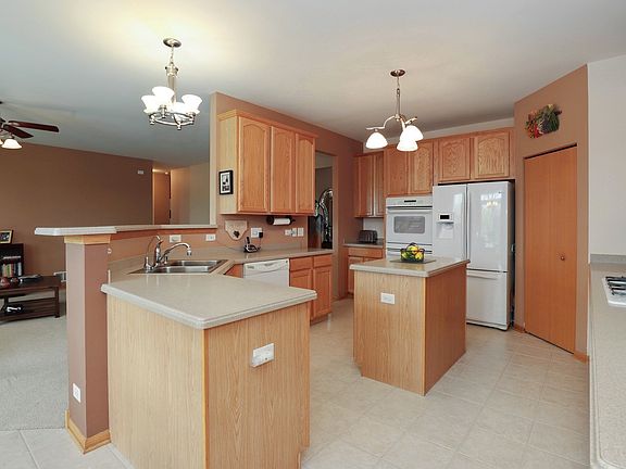 Enter Kitchen from Central Hall. Easily Converse with Family in Living Room