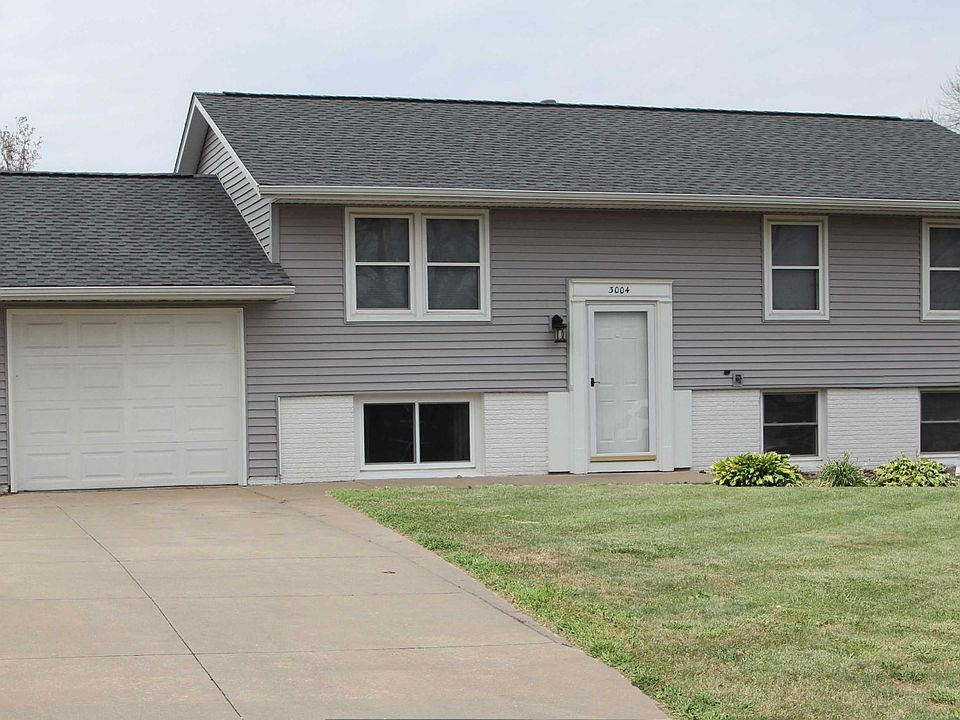 Front of home with extra wide driveway